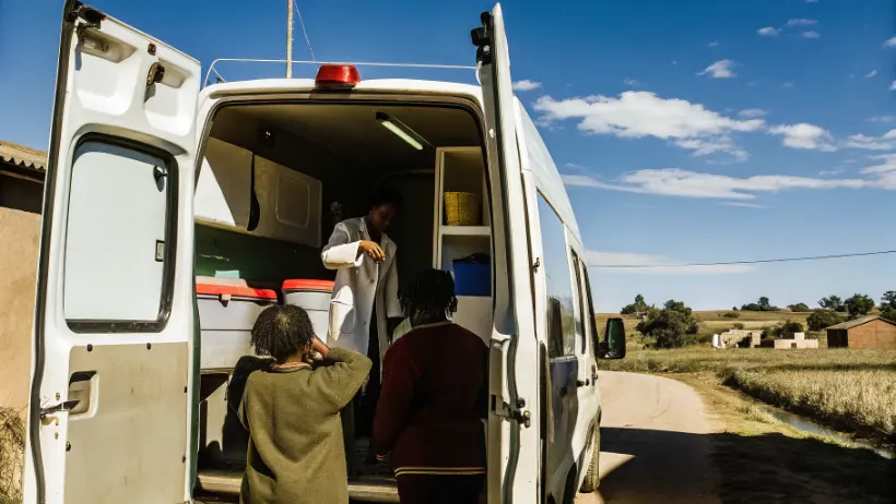 Mobile health clinic van with medical staff providing healthcare services to rural community members