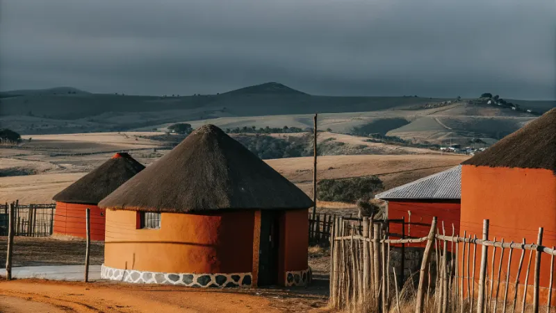 Rolling hills and rural homesteads in Msinga municipality showing traditional Zulu settlements against backdrop of Tugela River valley