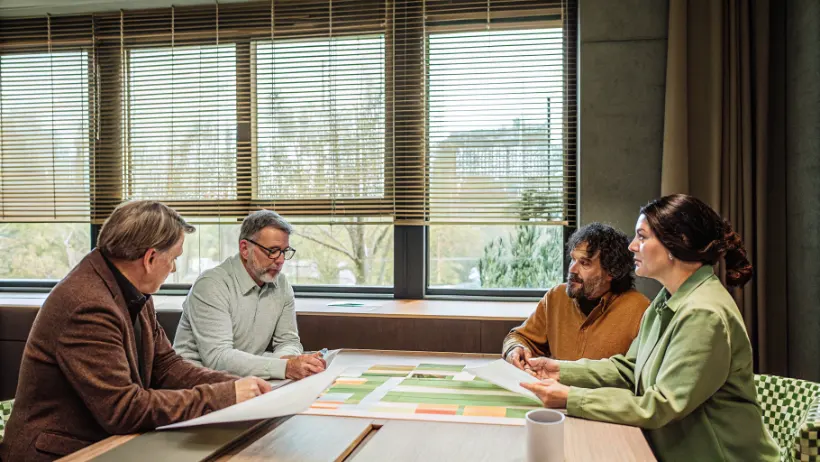 Municipal officials and community leaders discussing future development plans at strategic planning session